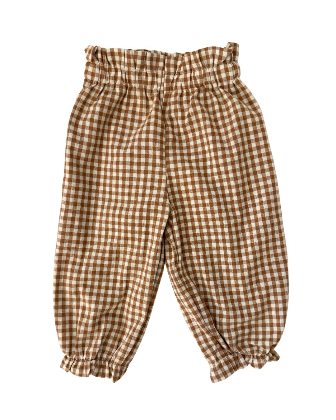 Brown and white checkered gingham pants on a white background