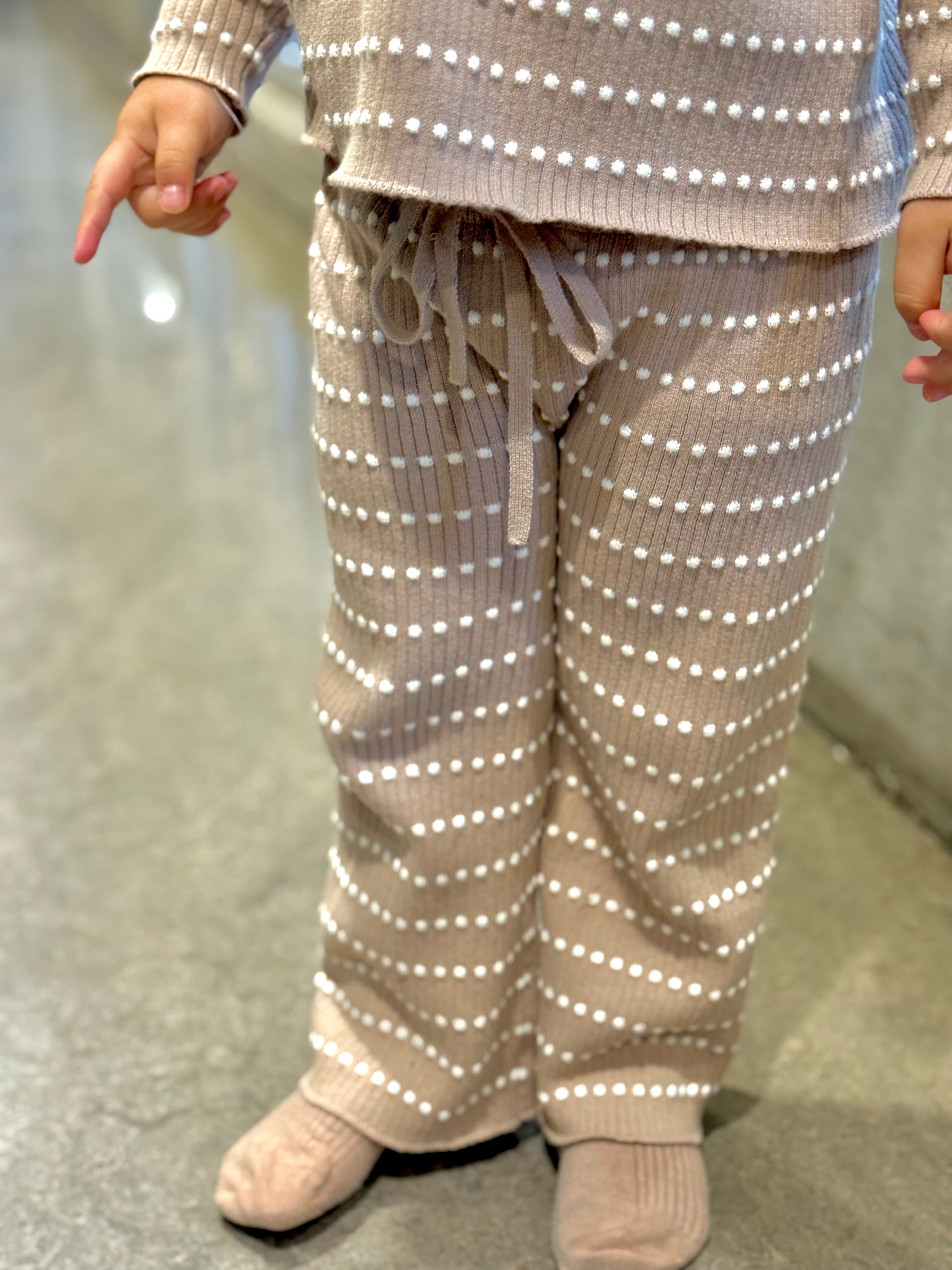 Front view of Atelier rib-knit pants worn by a child