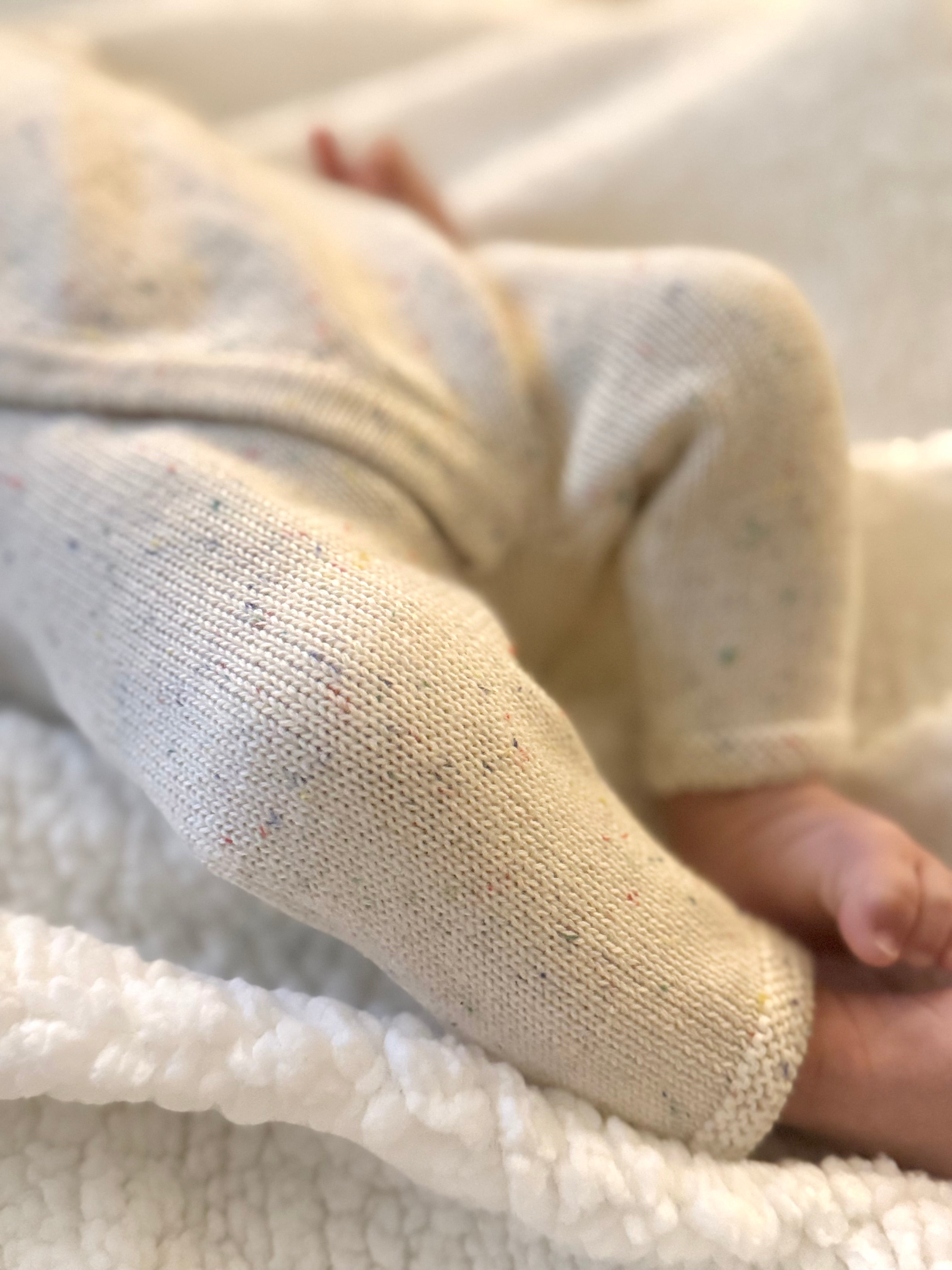 Close-up of the cream knit and cuff on a Confetti Tie Romper