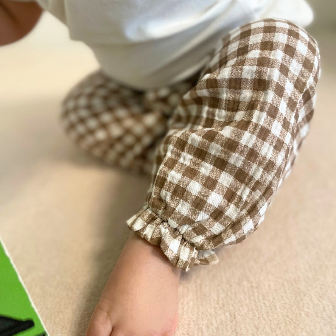 Close up of ankle details of brown gingham pants