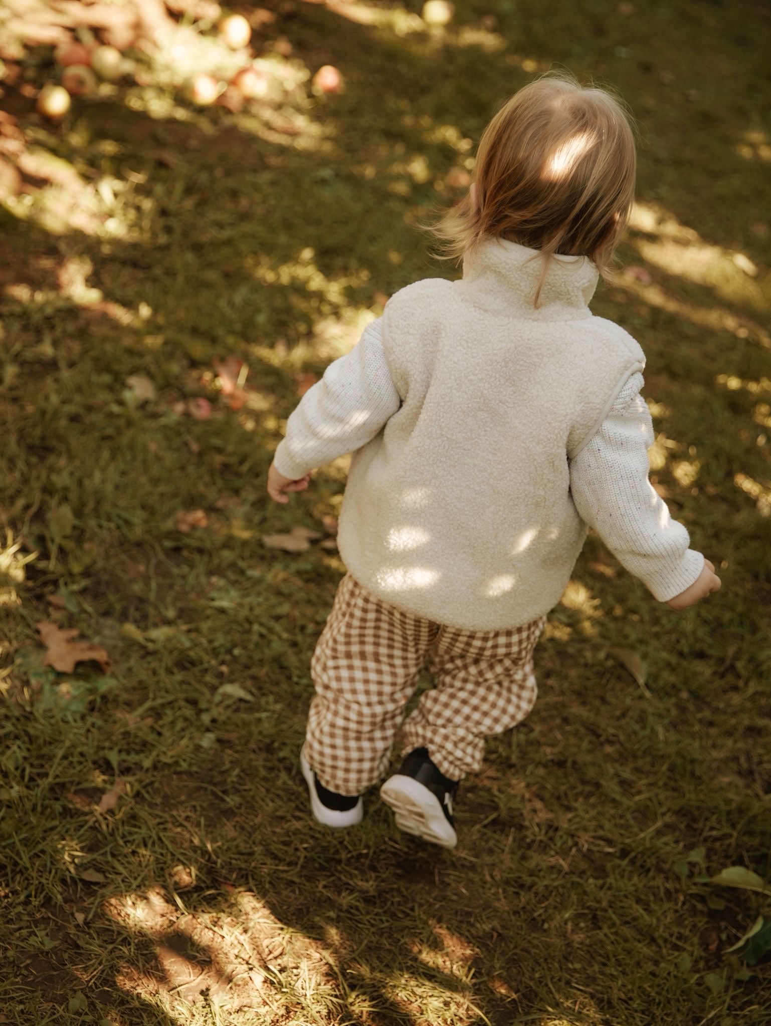 Child running outdoors on a grassy path