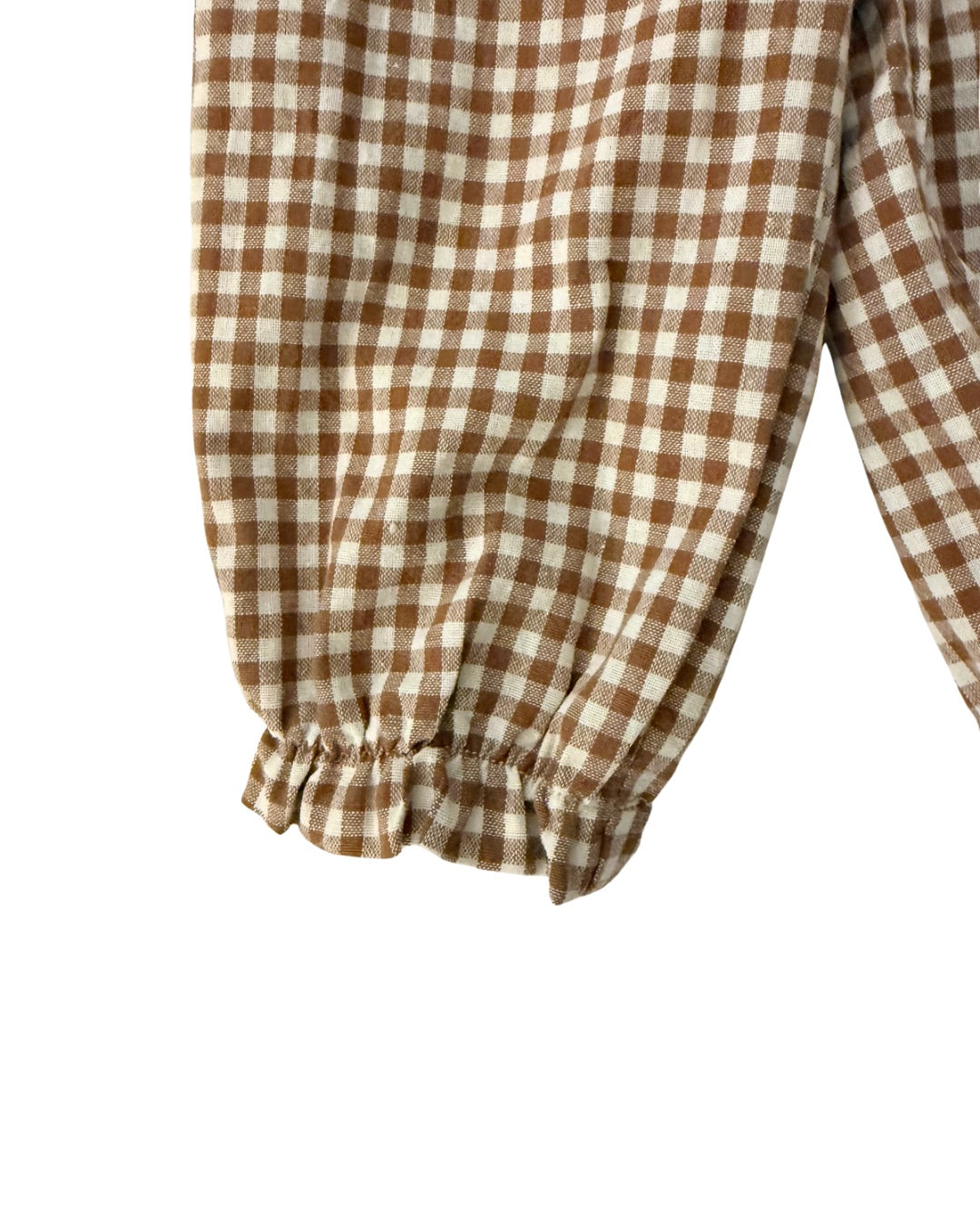 Brown and white checkered gingham pants cinched ankle detail on a white background