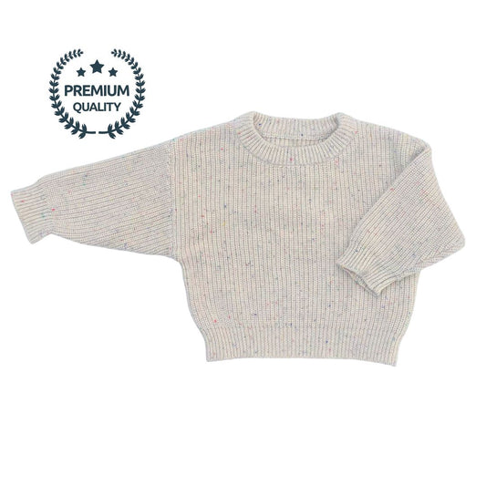 Flat lay of the Confetti Jumper, a 100% premium cotton knitted crew sweater in neutral beige with colorful specks. The soft, high-quality knit is visible, showcasing the playful and cozy design.