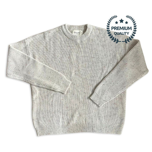 Flat lay of the Matching Mommy and Me Confetti Sweater set. The neutral beige color with colorful specks is showcased on both adult and baby sizes, made from soft, premium cotton. The cozy, playful design is perfect for matching family outfits.