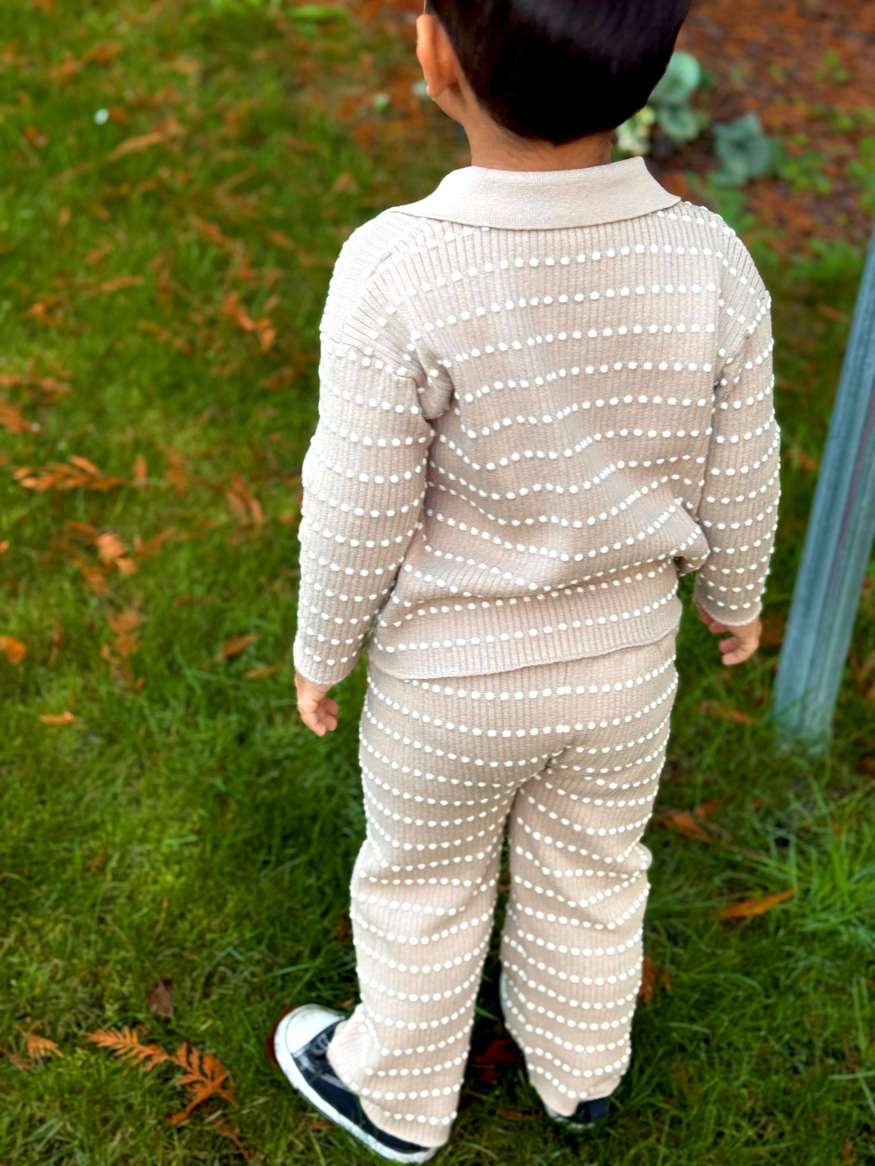 Back view of a child in an Atelier knit polo and pants set