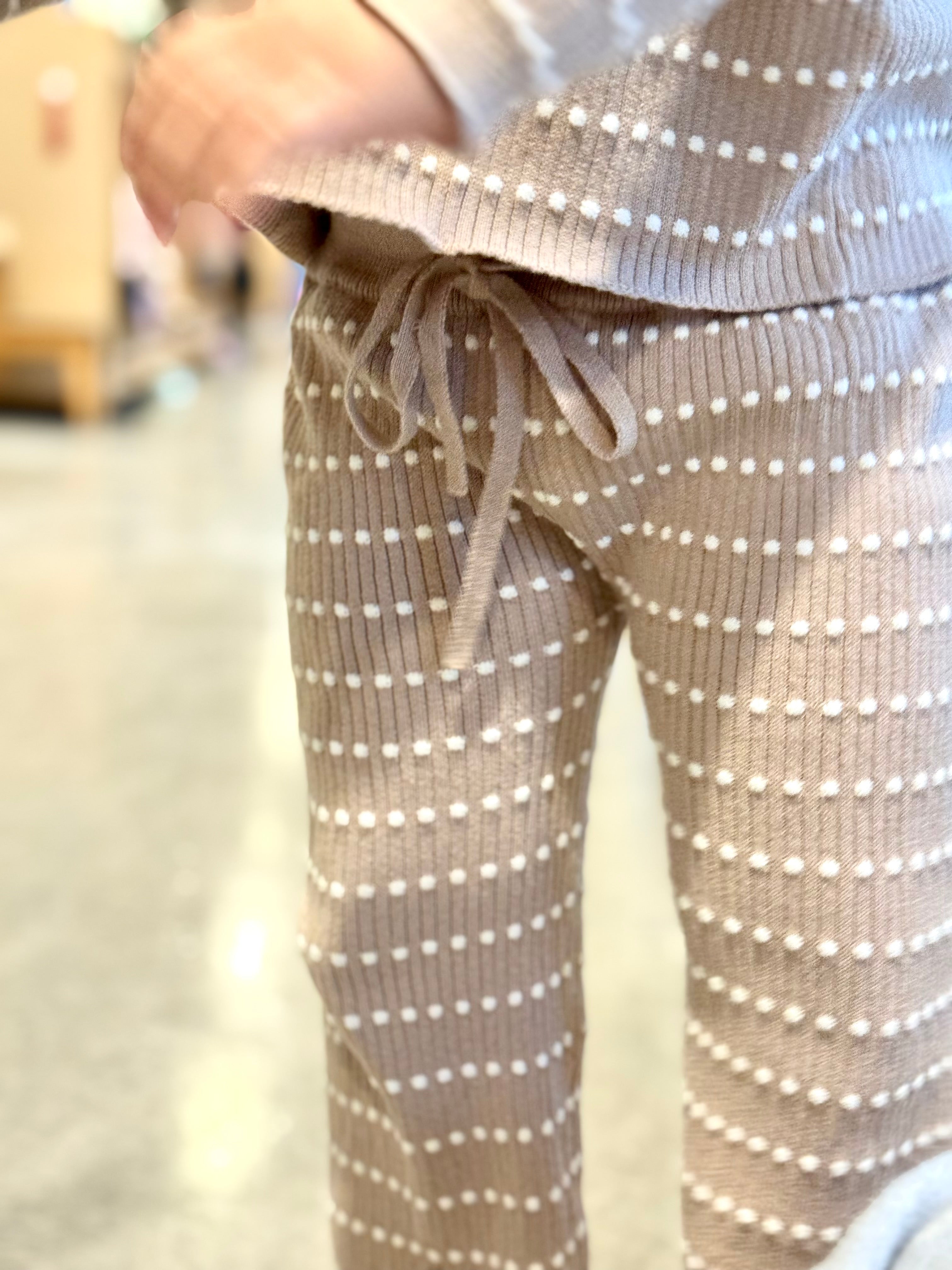 Close-up of Atelier knit pants and drawstring waist