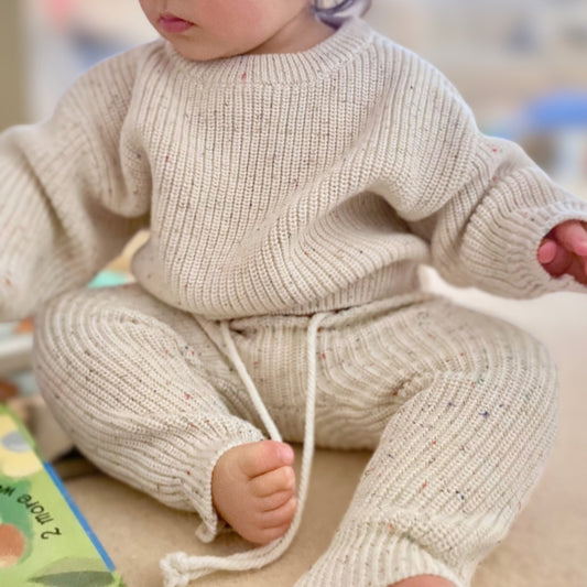 Close up of knitted confetti sweater and pant set