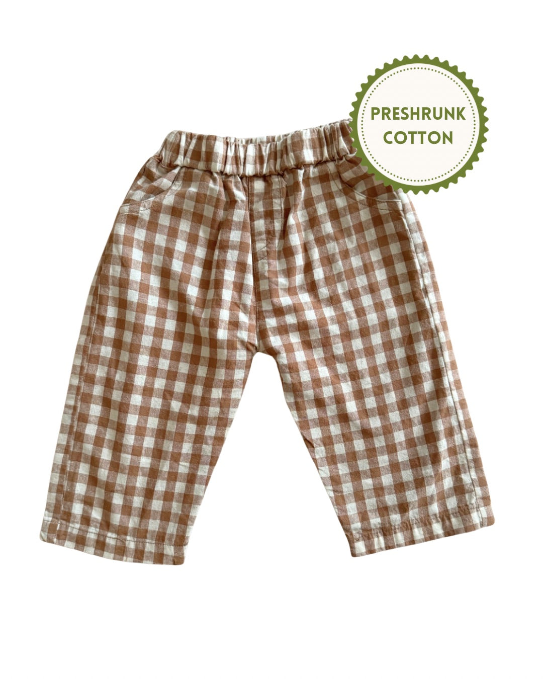 Brown and white checkered gingham pants with a 'Preshrunk Cotton' label on a white background