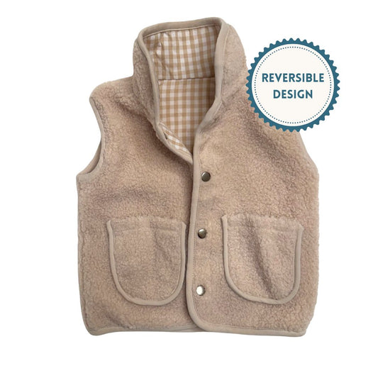 Beige reversible faux-sherpa vest with a beige gingham interior on a white background