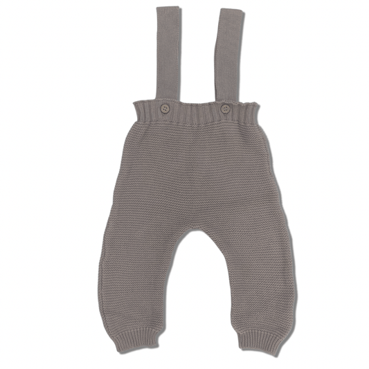 Flat lay of the Suspender Pants in Chai, featuring a beautiful garter stitch pattern, wooden buttons, adjustable buttons for growing babies, and ribbed cuffs. The soft, warm chai color adds to the cozy, stylish design.
